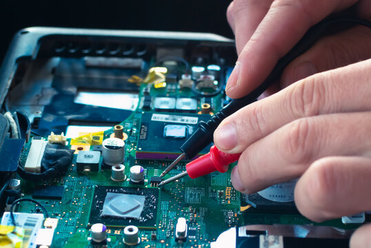 Hands fixing motherboard of pc or laptop notebook close up in service