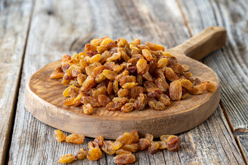 Raisins. Dry raisins on wood floor. Bulk Raisins grains