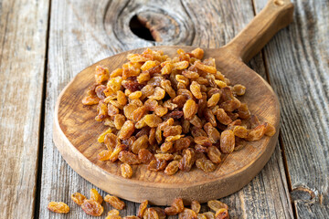 Raisins. Dry raisins on wood floor. Bulk Raisins grains