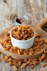 Dry raisins. Dry raisins nuts on wood floor. Bulk raisins grains. Raisins on a ceramic plate
