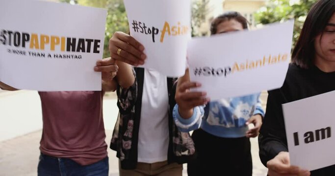 Group Of Mix Age Asian Women Holding A Paper With Words During Participants In Asian American Pacific Islanders Rally Marching Protest For Anti-racial And Ask To Stop Hate On AAPI Citizen.