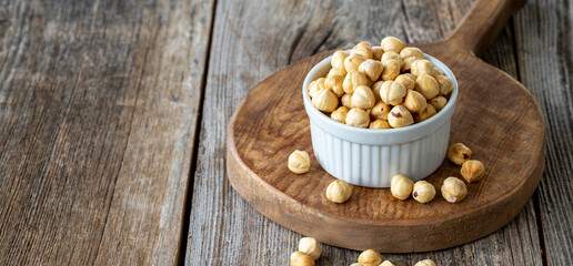 Roasted hazelnut. Hazelnut nuts on wood background. Bulk Hazelnut kernels. Copy Space