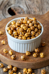 Roasted chickpea. Chickpeas nuts on wood floor. Bulk Chickpea grains. Chickpeas on a ceramic plate