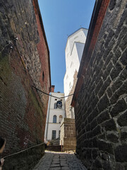 A narrow passage with a lantern suspended on chains, between the stone walls of the Vyborg Castle...