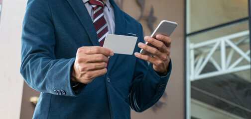 Businessman showing blank business card and holding smart phone..Business man holding white blank card space for text. product display montage.