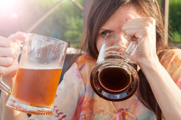 Female alcoholism, beer addiction, girl with a large mug of beer
