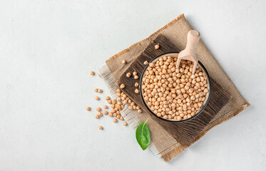 Organic, healthy chickpeas in a bowl on a light gray background.