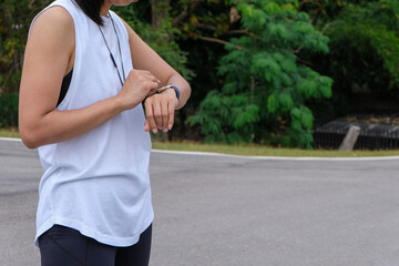 woman measuring smart watch with heart rate after running, health apps concept.