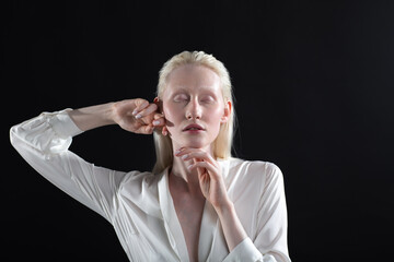 Young blonde albino woman doing face building facial gymnastics self massage and rejuvenating...