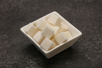 Refined white sugar cubs in the bowl