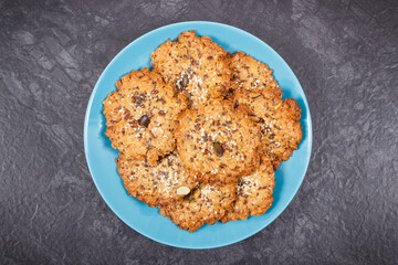 Fresh baked homemade healthy oatmeal cookies on blue plate. Delicious dessert
