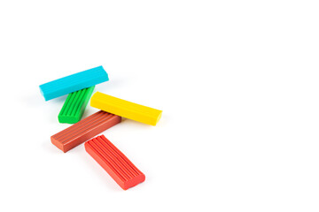 Multi-colored plasticine on a white background. Horizontal orientation, copy space.
