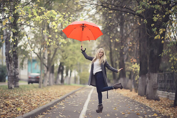Obraz premium girl with umbrella posing in autumn park, october landscape lonely woman holding a red umbrella