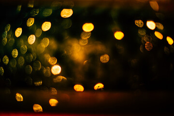 Abstract orange and gold dark background with glowing turquoise particles.
