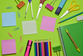 School supplies on green background and copy space.