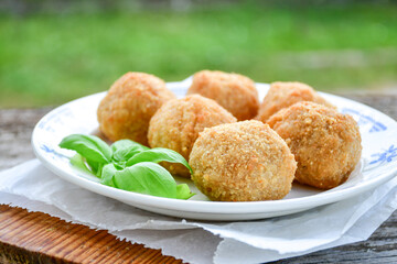 Italian arancini Cacio e pepe. Home made rice balls with mozzarella cheese ,parsley ,lemon and parmesan cheese.