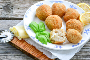 Italian arancini Cacio e pepe. Home made rice balls with mozzarella cheese ,parsley ,lemon and parmesan cheese.