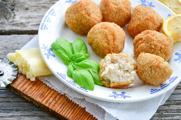 Italian arancini Cacio e pepe. Home made rice balls with mozzarella cheese ,parsley ,lemon and parmesan cheese.