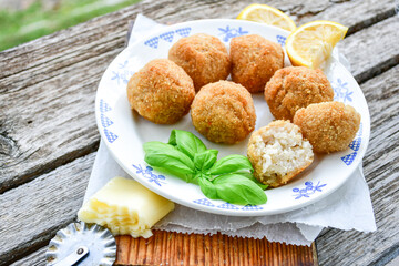 Italian arancini Cacio e pepe. Home made rice balls with mozzarella cheese ,parsley ,lemon and parmesan cheese.
