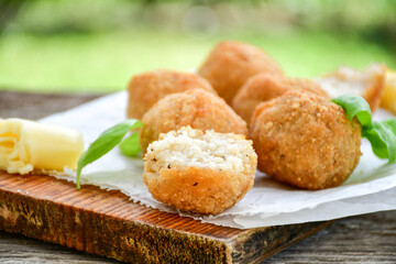 Italian arancini Cacio e pepe. Home-made rice balls with mozzarella cheese, parsley, lemon, and parmesan cheese.