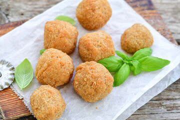 Italian arancini Cacio e pepe. Home-made rice balls with mozzarella cheese, parsley, lemon, and parmesan cheese.