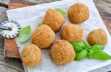 Italian arancini Cacio e pepe. Home-made rice balls with mozzarella cheese, parsley, lemon, and parmesan cheese.