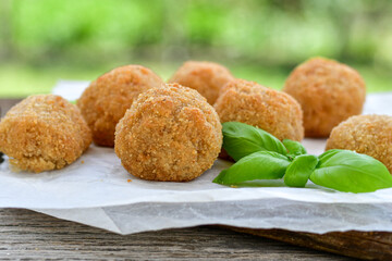 Italian arancini Cacio e pepe. Home-made rice balls with mozzarella cheese, parsley, lemon, and parmesan cheese.