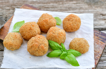 Italian arancini Cacio e pepe. Home-made rice balls with mozzarella cheese, parsley, lemon, and parmesan cheese.