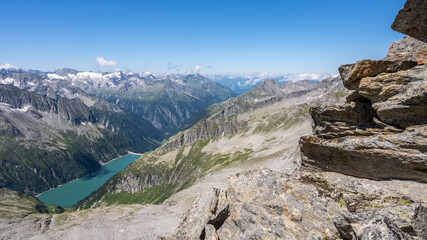 Fototapeta na wymiar Summer alpine scenery with turquoise blue water reservoir. Zillertal Alps, Austria