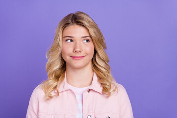 Photo of positive charming girl look interested empty space fantasize isolated on purple color background