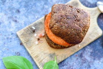 Homemade ketogenic  Salmon Burger with Tartar Sauce and  whole grain ketgenic bread. Healty food