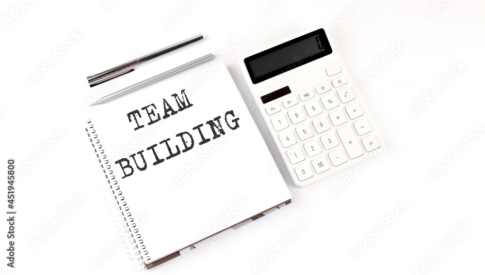 Poster notepad with text team building with calculator and pen. white background. business concept