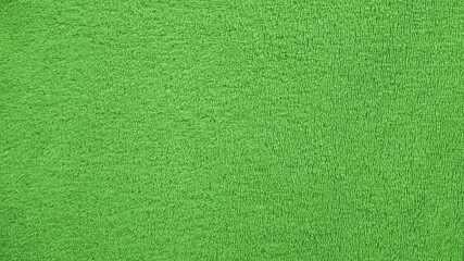 Texture of fluffy green cotton bath towel, Fabric cloth downy background, Close up