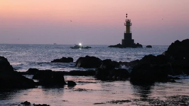 A ship and a lighthouse at Sunrise in Gimpo harbor, South Korea