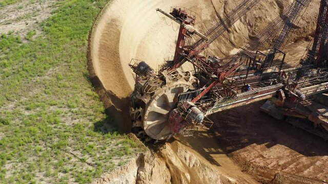 A large bucket-wheel excavator. Bucket-wheel excavator in open-cast mining. bucket wheel excavator ladles scoop overburden ground. Open Cast Mining