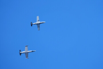 Two jet planes in flight. Aerobatic team performances.