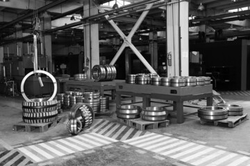 Production of bearings at the factory. Chrome plated surface. Industrial theme. Heavy industry. Black and white image.