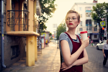 woman with short hair outdoors cup of drink lifestyle