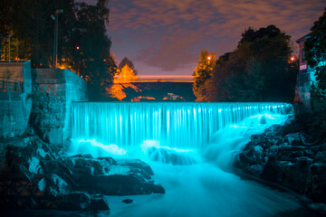 Rapids light up blue in the autumn night