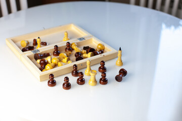 Symbol of competition. Chess board and chess figures on white table