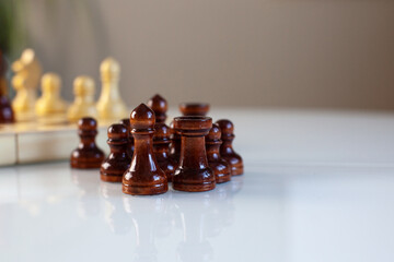 Leadership concept - the leader before the team is lined with chess pieces isolated on white