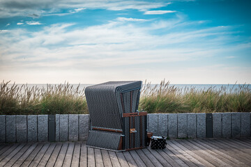 Precious brown wicker beach chair on promenade in Wenningstedt, Sylt, Germany