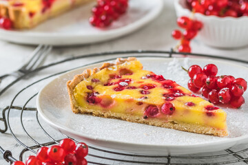Piece of homemade red currant pie on white background