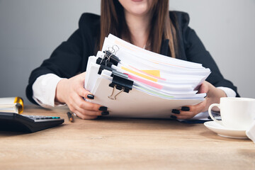 woman holding stack of business documents