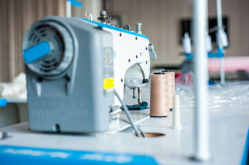 Interior of garment factory . Closes making atelier with several sewing machines. Tailoring industry, fashion designer workshop, industry concept
