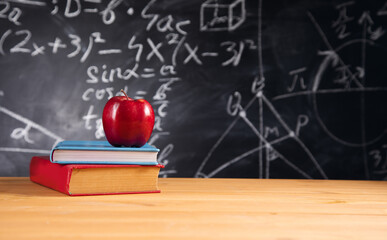apple on books with blackboard background