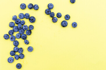 Trendy seamless pattern of blueberries. Blueberry pattern isolated on yellow background
