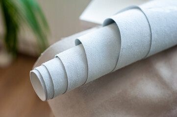 Fashion Design Studio. Hanging Clothes, Sewing Machine and Various Sewing Related Items on the Table, Mannequins Standing, Colorful Fabrics.