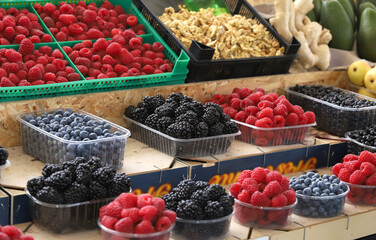 Colorful variety of berries background, ginger and nuts