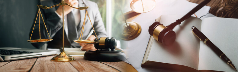 justice and law concept.Male judge in a courtroom on wooden table and Counselor or Male lawyer...